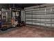 Spacious garage with epoxy floors, refrigerator, and ample storage at 466 Cool Summer Ln, Davenport, FL 33837