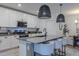 Modern kitchen featuring an island with seating, stainless steel appliances, and sleek countertops at 466 Cool Summer Ln, Davenport, FL 33837