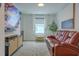 Comfortable living room with TV, entertainment center, plush leather seating, and natural light at 466 Cool Summer Ln, Davenport, FL 33837