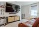 Cozy living room with entertainment center, plush leather seating, and natural light at 466 Cool Summer Ln, Davenport, FL 33837