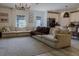 Bright living room showcasing a large sectional sofa, stylish lighting, and an open layout at 466 Cool Summer Ln, Davenport, FL 33837