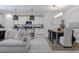 Open living space with kitchen island, dining area, and sofa offering a seamless flow for entertaining at 466 Cool Summer Ln, Davenport, FL 33837