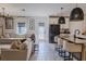 Open living space with kitchen island, dining area, and sofa offering a seamless flow for entertaining at 466 Cool Summer Ln, Davenport, FL 33837