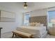 Bright bedroom featuring a large bed, neutral colors, and natural light at 466 Cool Summer Ln, Davenport, FL 33837