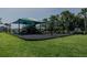 Community playground with shaded area, playground equipment and lush landscaping at 466 Cool Summer Ln, Davenport, FL 33837