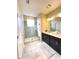 Modern bathroom with double vanity, walk-in shower, and tile flooring at 4736 Tribute Trl, Kissimmee, FL 34746