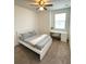 This carpeted bedroom includes a bed, window with blinds, ceiling fan, and a desk with chair at 4736 Tribute Trl, Kissimmee, FL 34746
