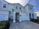 Charming townhome featuring a private entrance with seating and manicured landscaping at 4736 Tribute Trl, Kissimmee, FL 34746