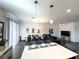 Open-concept living space with quartz countertops, modern finishes and great lighting at 4736 Tribute Trl, Kissimmee, FL 34746