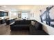 Open-concept living area with dark furniture, wood floors and abundant natural light at 4736 Tribute Trl, Kissimmee, FL 34746