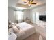 This main bedroom features a tray ceiling, ceiling fan, carpeted floor, and a dresser for extra storage at 4736 Tribute Trl, Kissimmee, FL 34746