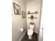 Cozy half bathroom featuring stylish decor, wood-look floors, and modern fixtures at 4736 Tribute Trl, Kissimmee, FL 34746