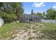 Sprawling backyard features screened-in lanai with pool, lush lawn, and mature trees at 5254 Mill Stream Dr, St Cloud, FL 34771