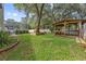 Expansive backyard showcasing lush lawn, privacy fence, wooden gazebo and screened-in lanai at 5254 Mill Stream Dr, St Cloud, FL 34771