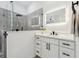 This bathroom has a glass shower, white vanity, and a sleek, modern illuminated mirror that adds luxury to the space at 5254 Mill Stream Dr, St Cloud, FL 34771