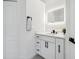 Well-lit bathroom featuring a modern, illuminated mirror, white vanity with sleek hardware and a neutral-toned color palette at 5254 Mill Stream Dr, St Cloud, FL 34771