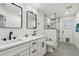 A bright bathroom featuring double vanities with modern faucets, illuminated mirrors, and a glass-enclosed shower at 5254 Mill Stream Dr, St Cloud, FL 34771