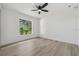 This bedroom features a modern ceiling fan and a window showcasing verdant scenery, offering a bright and airy feel at 5254 Mill Stream Dr, St Cloud, FL 34771