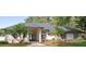 Charming single story home with mature landscaping, decorative lighting, and a walkway to the front door at 5254 Mill Stream Dr, St Cloud, FL 34771