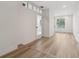 Bright hallway with light wood floors, white walls, and natural light, offering a clean and inviting transition between rooms at 5254 Mill Stream Dr, St Cloud, FL 34771
