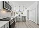 Bright kitchen features stainless steel appliances, white cabinets, modern pendant lighting, and a farmhouse sink at 5254 Mill Stream Dr, St Cloud, FL 34771