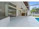 Covered outdoor kitchen featuring a sink, storage, and a ceiling fan with views of the screened-in pool at 5254 Mill Stream Dr, St Cloud, FL 34771
