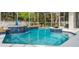 Inviting screened-in pool with blue tile accents and lush greenery providing a private oasis at 5254 Mill Stream Dr, St Cloud, FL 34771