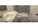 Bathroom features a tiled shower, a toilet, and a vanity with a sink at 553 Se Turtle, Haines City, FL 33844