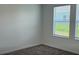 Cozy bedroom features neutral walls, plush gray carpet, and a bright window with blinds at 553 Se Turtle, Haines City, FL 33844
