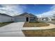 Charming single-story home with a well-manicured lawn, a gray exterior, and a two-car garage at 553 Se Turtle, Haines City, FL 33844