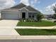 Charming single-story home with a manicured lawn and beautiful landscaping in a well-kept neighborhood at 553 Sea Turtle Ln, Haines City, FL 33844