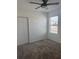 Comfortable bedroom featuring carpet, a closet, and bright natural light through a window with blinds and ceiling fan at 553 Sea Turtle Ln, Haines City, FL 33844