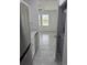 Stylish kitchen with stainless steel refrigerator, appliances, countertops, and a view to the living area and laundry at 553 Sea Turtle Ln, Haines City, FL 33844