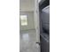 Bright and airy living room showcasing tiled floors, a window, and a discreetly placed washer and dryer at 553 Sea Turtle Ln, Haines City, FL 33844