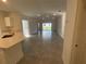 Bright, open-concept living room and kitchen area with recessed lighting and sliding glass doors to the outside at 553 Sea Turtle Ln, Haines City, FL 33844