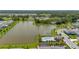 High aerial view of a community with a lake, walking trails, and neighborhood pool at 5648 Cedar Chase Dr, St Cloud, FL 34771