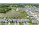 An aerial view of a home in a community with a lake, pool, and a golf course in the distance at 5648 Cedar Chase Dr, St Cloud, FL 34771