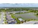Aerial view shows the home in a lakeside community, near neighborhood pool and clubhouse at 5648 Cedar Chase Dr, St Cloud, FL 34771