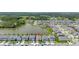 Aerial view of a home in a community bordering a large lake on a sunny day at 5648 Cedar Chase Dr, St Cloud, FL 34771