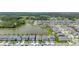 Aerial view of a home in a community bordering a large lake on a sunny day at 5648 Cedar Chase Dr, St Cloud, FL 34771