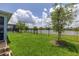 Backyard with black metal fence overlooking a pond, and a glimpse of a pool in the background at 5648 Cedar Chase Dr, St Cloud, FL 34771
