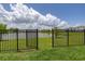The backyard has a gate and black aluminum fence with a lovely pond view at 5648 Cedar Chase Dr, St Cloud, FL 34771