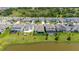 Aerial view of a backyard with a screened in pool, lush green lawn. A FedEx truck is parked in the driveway at 5648 Cedar Chase Dr, St Cloud, FL 34771