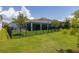 Spacious, fenced backyard with screened porch, pool view, and lush green lawn at 5648 Cedar Chase Dr, St Cloud, FL 34771
