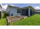 Landscaped backyard featuring raised garden beds, screened porch, and black aluminum fence at 5648 Cedar Chase Dr, St Cloud, FL 34771