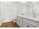Bright bathroom with a double sink vanity, wood-look tile floor, and a large mirror at 5648 Cedar Chase Dr, St Cloud, FL 34771