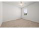 Bedroom features neutral carpeting, a ceiling fan, and a window with blinds at 5648 Cedar Chase Dr, St Cloud, FL 34771