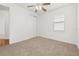 Bedroom with neutral carpeting, ceiling fan, window, and a double-door closet at 5648 Cedar Chase Dr, St Cloud, FL 34771