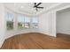 Large room with wood flooring, tray ceiling, and large windows for plenty of natural light at 5648 Cedar Chase Dr, St Cloud, FL 34771
