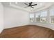 Large room with wood flooring, tray ceiling, and large windows for plenty of natural light at 5648 Cedar Chase Dr, St Cloud, FL 34771